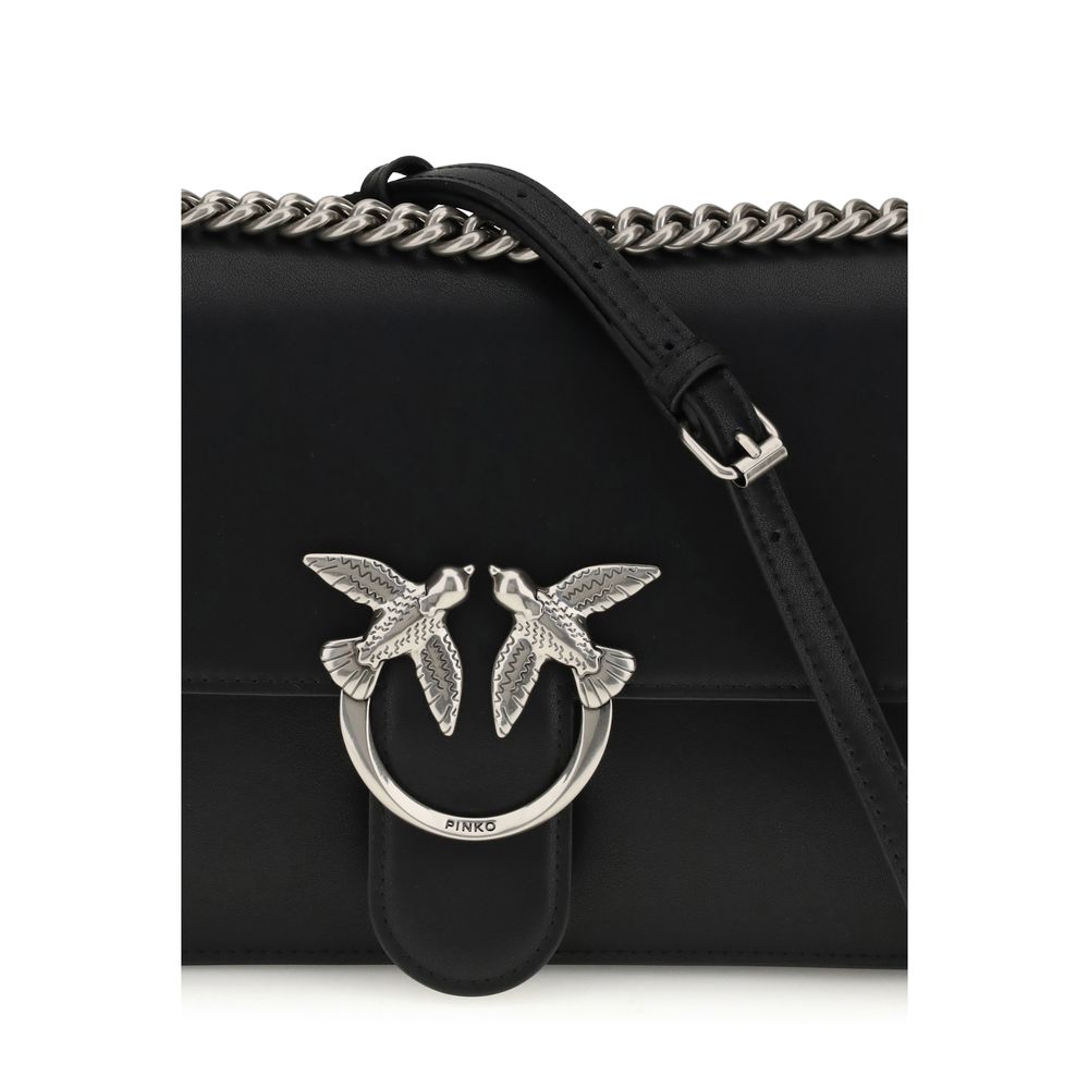 Black handbag with silver bird embellishments and a chain strap on a white background