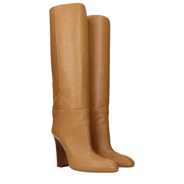 Pair of tan knee-high boots on a white background