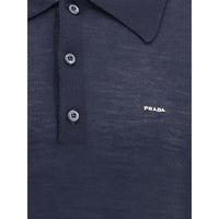 Navy blue Prada polo shirt with buttons on a white background