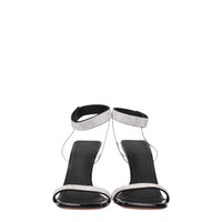 Black high-heeled sandals with rhinestone straps on a white background